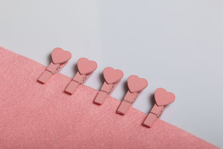 Subjects for needlework. Cloth and wooden clothespins with hearts.の写真素材