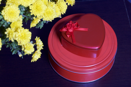 Autumn flowers in a pot. Yellow Chrysanthemum. Next gifts in tin boxes.の写真素材