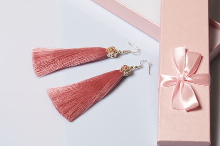 Earrings made of viscose handmade. Together with wrapping gift boxes. Against the white background.の写真素材