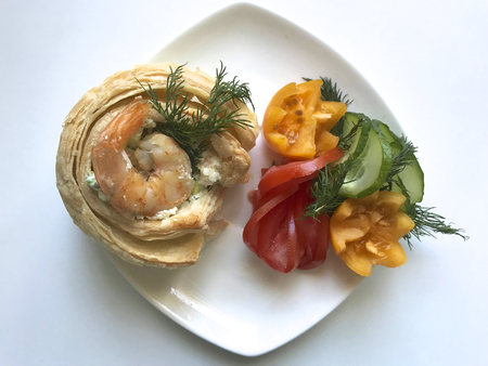 Woman cleans boiled shrimp. Next on the table are vegetables and curd mass for cooking.の写真素材
