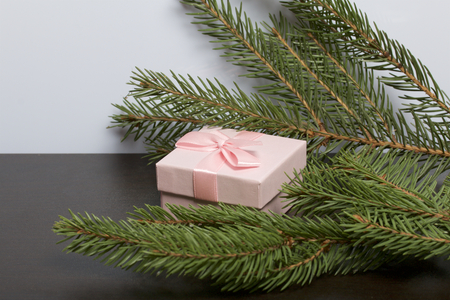 Wrapping presents. Gift boxes. Nearby are green branches of spruce.の写真素材