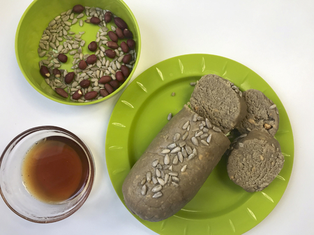 Halva, cooked at home. Nearby are the ingredients for its preparation of roasted peanuts, seeds and...
