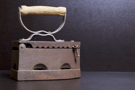 Old iron, heated by hot coals. Located on a dark background.の写真素材