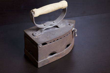 Old iron, heated by hot coals. Located on a dark background.の写真素材
