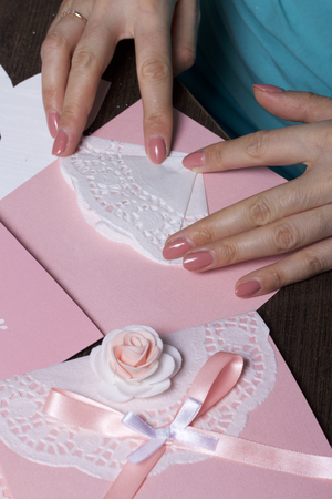 Making greeting cards from paper, cardboard and tape. Woman artisan at work.の写真素材
