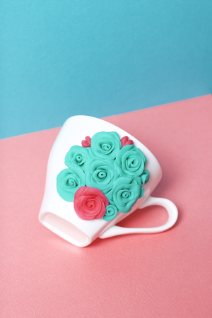 Mug, decorated with flowers made of polymer clay. Crafts from polymer clay. Mug decorated with stucco made of polymer clayの写真素材