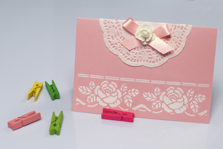 Making greeting card from paper, cardboard and tape. Near the surface are decorative accessories.の写真素材