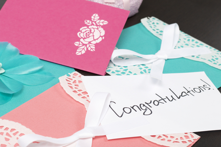 Handmade greeting cards. Near gift in wrapping paper, tied with a ribbon. Original gift.の写真素材