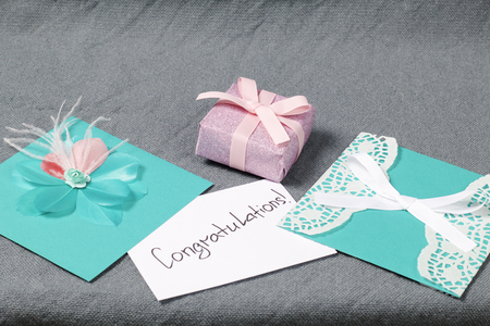 Handmade greeting cards. Near gift in wrapping paper, tied with a ribbon. Original gift.の写真素材