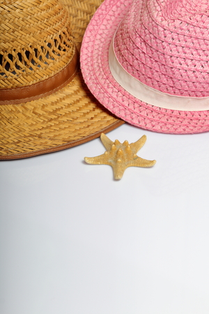 Accessories for summer holidays. Sun hats and starfish on a white background.の写真素材