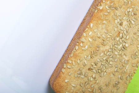 Baking bread at home. A loaf of freshly baked wholegrain bread with sunflower seeds lies on a...