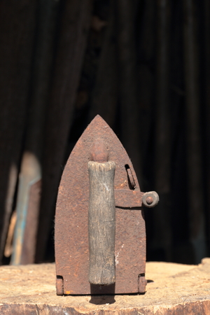 Rare iron working on coals. Located on a wooden deck.の写真素材