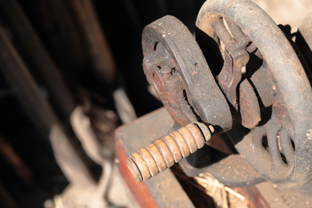 Old sewing machine, with manual drive. Covered with corrosion, dust and cobwebs.の写真素材