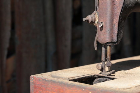 Old sewing machine, with manual drive. Covered with corrosion, dust and cobwebs.の写真素材