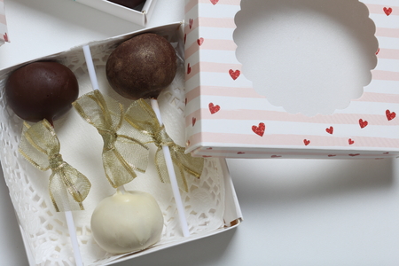 Cake pops decorated with a bow of braid, packed in a gift box.の写真素材