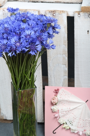 Bouquet field cornflowers and a greeting card. Cornflower or Blue (Centaurea cyanus), with spider-woolly linear-lanceolate leaves and blue flowers.の写真素材