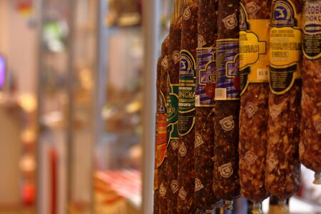 MINSK, MINSK, BELARUS 6 JUNE 2019, Exposition at the exhibition BELAGRO 2019. Products of meat processing industry. Sausages hang in a row, enticing visitors.のeditorial素材