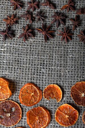 Dried orange and anise slices for decoration. Laid out on a rough linen fabric