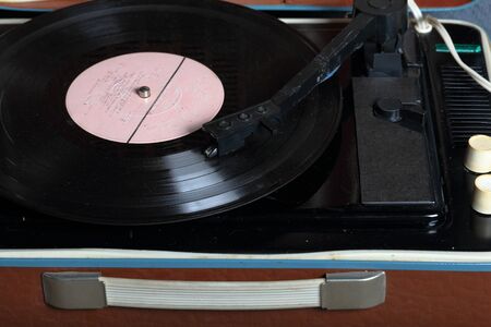 An old gramophone with a vinyl record mounted on it.