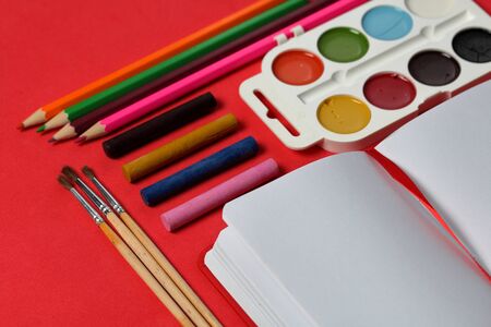 Accessories for drawing and sketching. Decomposed on the surface of coral color. In the middle of...