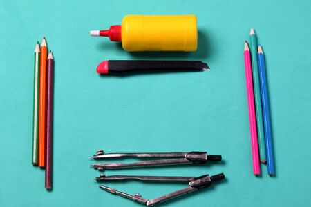 Accessories for drawing, drafting and application. Laid out on a mint background. School supplies.