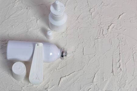 White spray nasal and oral spray. They lie on the surface covered with white decorative plaster.