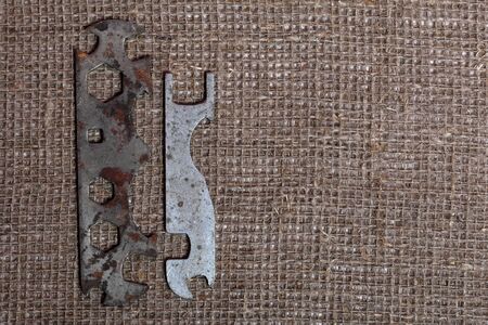 Wrenches for different sizes. Worn and covered with corrosion. They lie on a rough linen cloth.