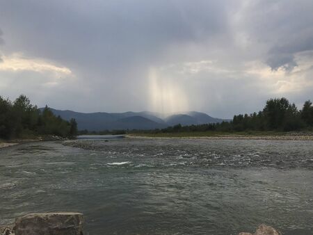 Landscapes of Transcarpathia. Stormy streams of a mountain river flow in the valley. Mountains are...