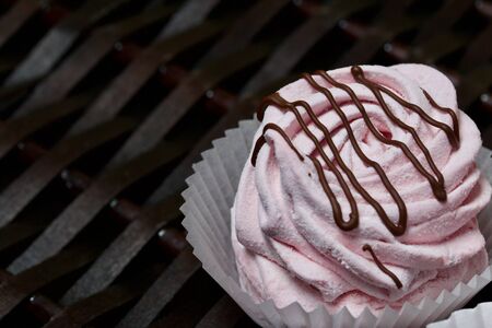 Aerial pink cherry marshmallows. Garnished with Chocolate. Against the background of wicker vines.