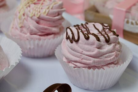Aerial pink cherry marshmallows. Different shapes and sizes. Sprinkled with dextrose. Garnished with Chocolate.の写真素材