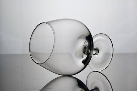 Short-stemmed wine glass. Lies on its side, photographed in the light.の写真素材