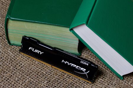 MINSK, BELARUS - NOVEMBER 25, 2019: RAM Bar HyperX Fury 8GB DDR4. Nearby are two thick books.