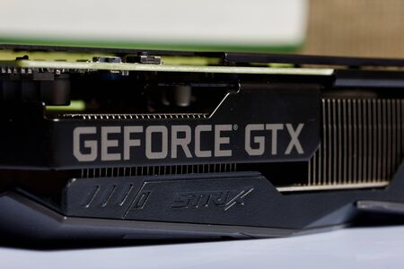MINSK, BELARUS - NOVEMBER 25, 2019: A man opens the package with the ROG Strix GeForce GTX 1660 Ti...