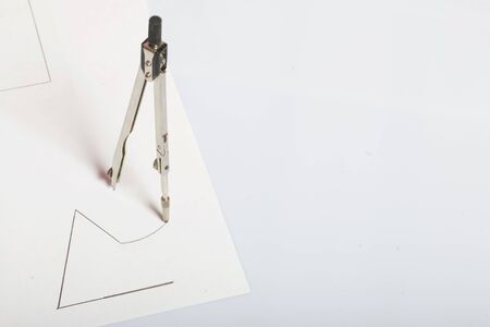 A figure drawn by a compass on white paper. Triangle, circle and compass in space.の写真素材