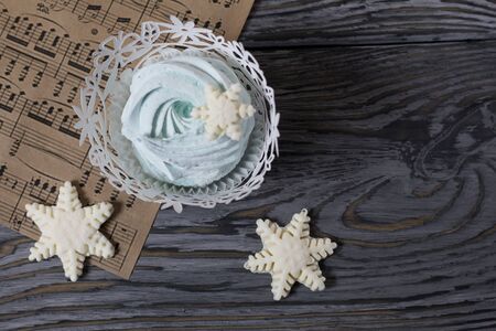 Marshmallows and snowflakes from marshmallows. On old pine boards painted black.の写真素材