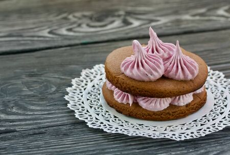 Marshmallows sandwiches made from chocolate dough and blueberry marshmallows. On a lace napkin, on...