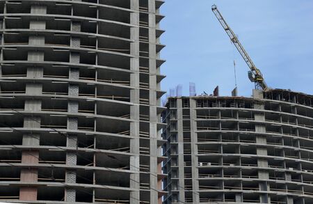 High-rise building under construction. Reinforced concrete frame. Construction cranes are visible.