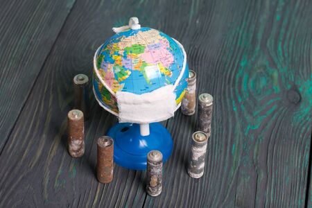 Spent finger-type batteries coated with corrosion. Stand around a lobus with a gauze bandage. Environmental protection, Earth Day.の写真素材