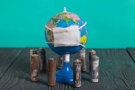 Spent finger-type batteries coated with corrosion. Stand around a lobus with a gauze bandage. Environmental protection, Earth Day.の写真素材