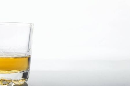 Glass transparent glass with strong alcohol. On a white background.