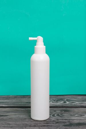 White plastic spray gun. With a disinfectant. On a green background.の写真素材