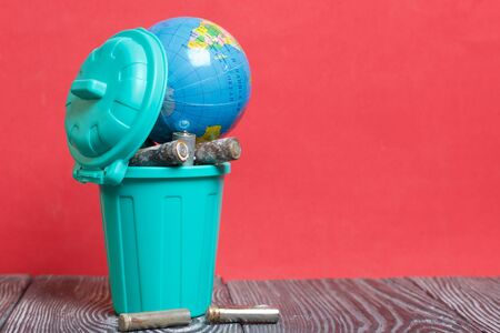 Trash can with lid filled with waste batteries. The batteries are covered with corrosion. The...