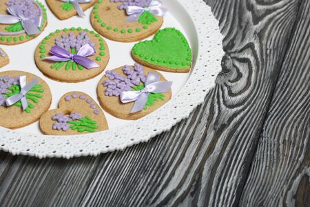 Gingerbread cookies decorated with glaze. On some ribbons tied to a bow. Gingerbread cookies are...