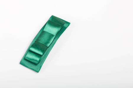Hair clip made of green ribbon. On white background.の写真素材
