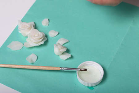 Roses with petals made of white polymer clay. Glue and brush. Crafts from polymer clay.の写真素材