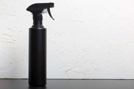 Spray bottle with antiseptic, black. For surface treatment against viruses. On a white background.の写真素材