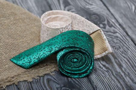 Two men's ties in different colors and sizes. For father and son. A piece of linen cloth. Love and...