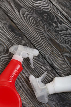 Plastic bottles of white and red color with a spray gun. Cleaning spray. Against a background of...