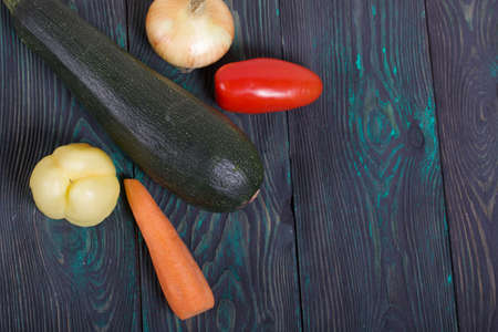 Canned zucchini caviar in a jar. Nearby on the table surface are vegetables, ingredients for cooking.の写真素材