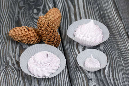 Zephyr and spruce cones. On painted pine planks.
